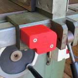 Red Mag Shims woodworking shim on metal jointer fence in workshop setting
