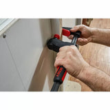 Woodworker using a BESSEY clamp to secure a panel during woodworking project