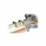 Miter saw station with adjustable stop block, measuring fence, and wooden workpiece