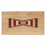 Woodworking inlay sample with multi-color bow tie design on a rectangular wooden board