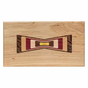 Woodworking inlay sample with multi-color bow tie design on a rectangular wooden board