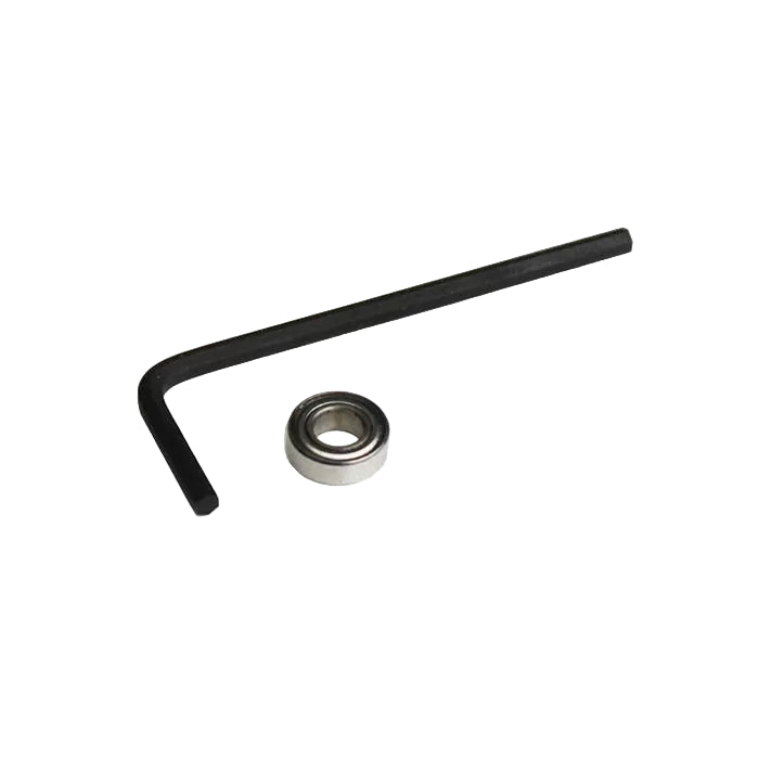 L-shaped hex key and small metal bearing for woodworking tool maintenance