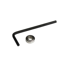 L-shaped hex key and small metal bearing for woodworking tool maintenance