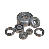 Assorted metal ball bearings for woodworking tools on white background