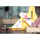 Woodworker using a yellow router table height gauge to set router bit and wood thickness