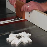 Woodworker using table saw and box joint jig for precise woodworking cuts