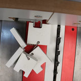 Table saw setup blocks with measurement markings on a saw blade and miter gauge