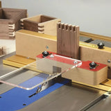 Box joint jig on table saw cutting precise finger joints in wood for woodworking projects