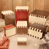 Assorted wooden boxes with precise finger joints, showcasing woodworking joinery techniques.