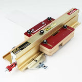 Precision woodworking box joint jig with gold and red metal components on white background