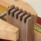 Close-up of dovetail joint woodworking with jig and router table