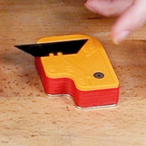 Woodworking utility blade with safety holder on a workbench