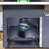 Router installed inside a black router table cabinet in a woodworking workshop