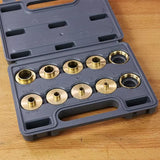 Woodworking brass router guide bushing set in a plastic case on a workbench