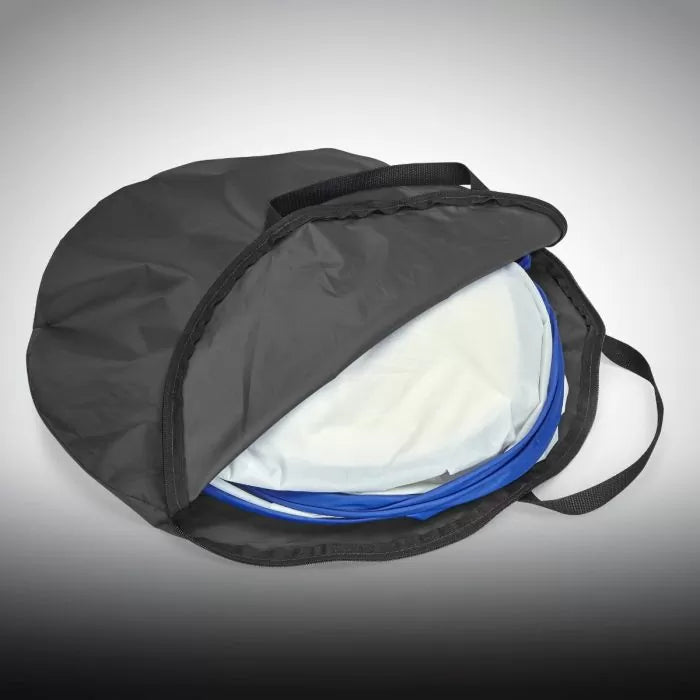 Mini spray shelter folded in a black carrying bag with handles for woodworking projects