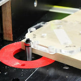 Router table with straight router bit cutting wood using an acrylic jig for precise woodworking.