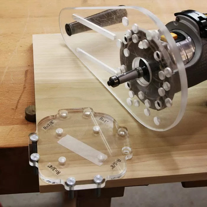 Acrylic router template jig and base on a wood workbench with a handheld router tool.