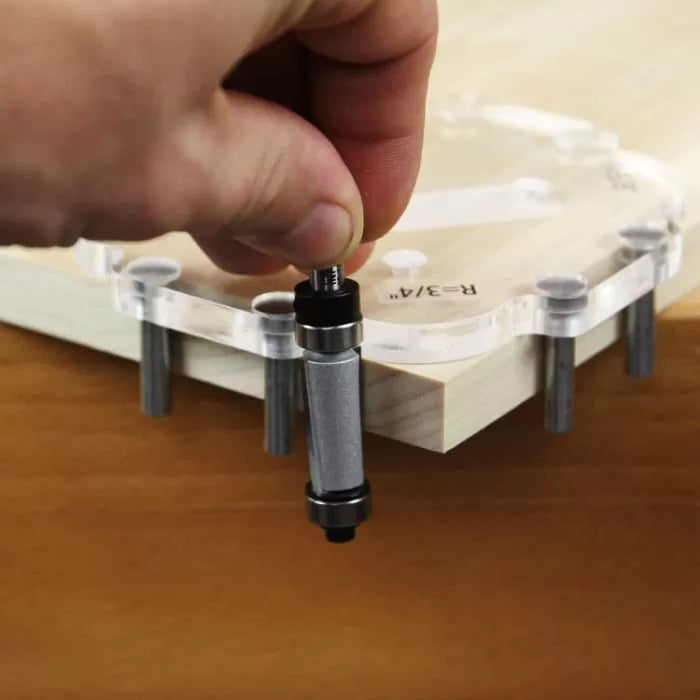 Hand placing alignment pin in woodworking router template on wood corner