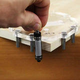 Hand placing alignment pin in woodworking router template on wood corner