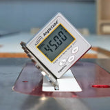 Digital angle gauge measuring 45 degrees on a table saw blade for woodworking precision