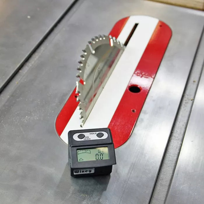 Table saw blade with digital angle gauge on metal surface for woodworking precision