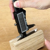 Digital caliper measuring wooden block for woodworking precision