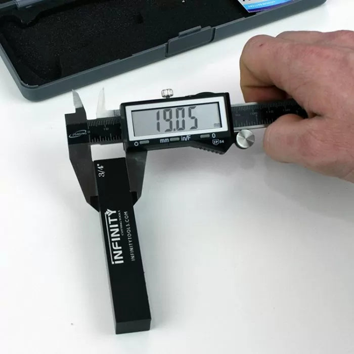 Digital caliper measuring black 3/4 inch gauge block for woodworking accuracy