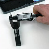 Digital caliper measuring black 3/4 inch gauge block for woodworking accuracy