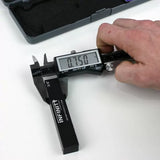 Digital caliper measuring woodworking setup block reading 0.750 inches on display