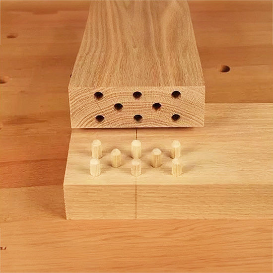 Close-up of dowel joint woodworking with aligned dowel holes and inserted dowel pins
