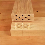 Close-up of dowel joint woodworking with aligned dowel holes and inserted dowel pins