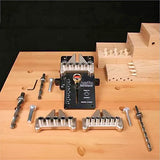 Woodworking dowel jig set with drill bits and alignment guides on a workbench