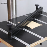 Aluminum drill press fence mounted on a woodworking drill press table with T-tracks.