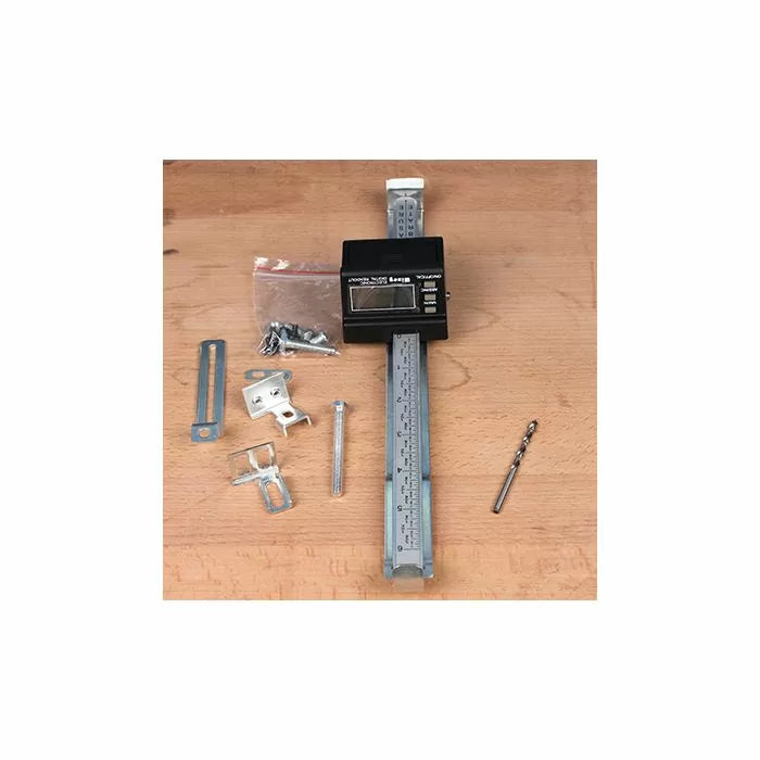 Digital fence ruler kit with metal brackets, screws, and drill bit on a wooden surface