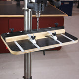 Drill press table with adjustable fence and hold-down clamps for woodworking