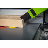 Push block guiding wood on table saw for safe woodworking and precise cutting