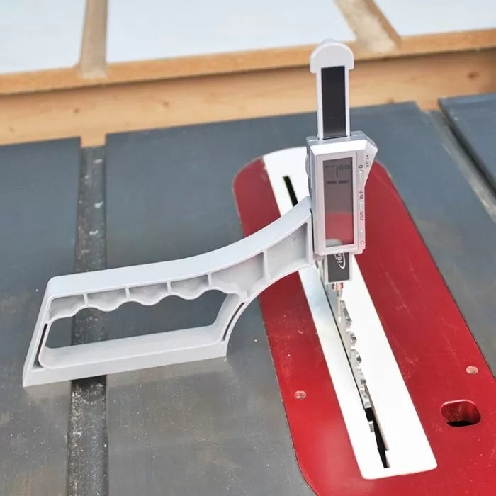 Digital height gauge measuring table saw blade height on a woodworking table