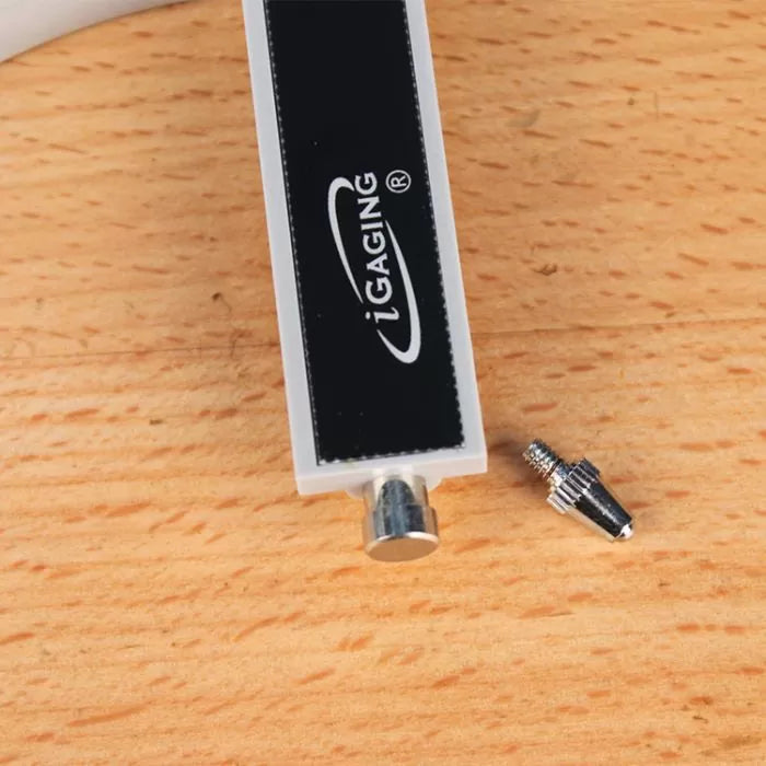 Digital caliper depth gauge attachment with metal contact point and screw on wood surface.