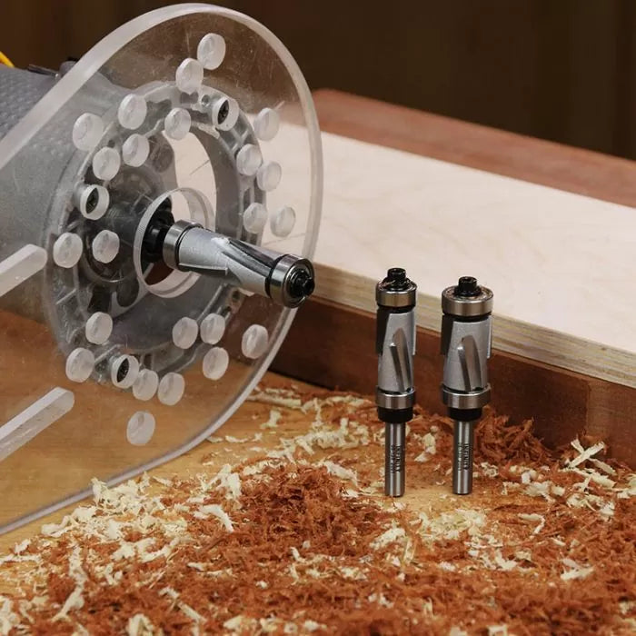 Woodworking router with two spiral router bits on a workbench with wood shavings