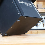 Close-up of black woodworking tool cabinet base with leveling feet on workshop bench