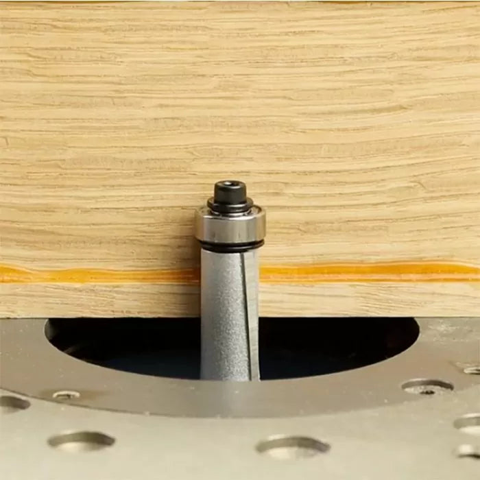 Flush trim router bit cutting wood edge on a router table