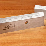 Stainless steel precision woodworking square ruler with metric markings on a wood surface