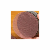 Close-up of round mesh sanding disc on hand block for woodworking