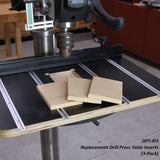 Drill press with replacement table inserts on a woodworking table in a workshop setting