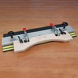 Woodworking router table jig with aluminum rails and clamps on a wooden surface