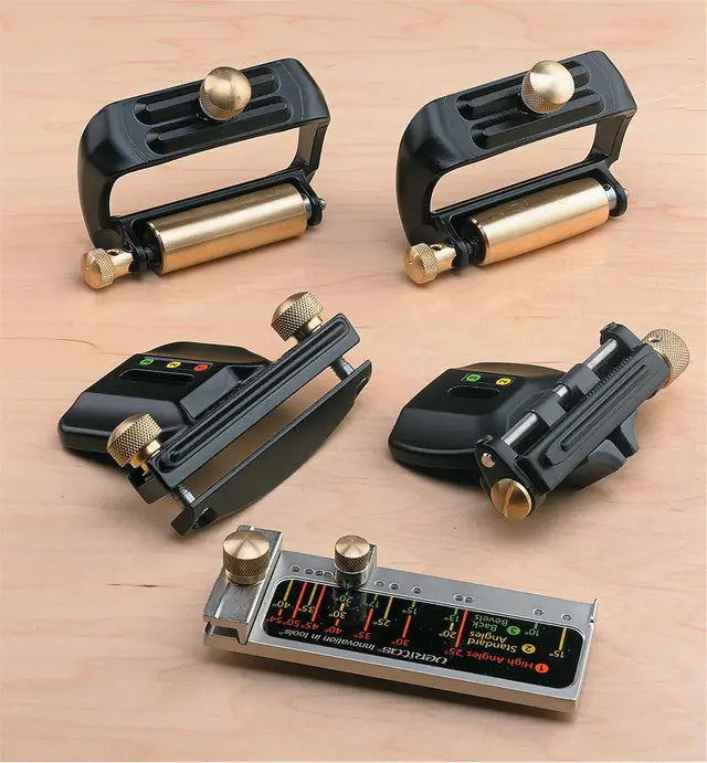 Angle guide jigs and woodworking tool accessories on a wooden workbench for precise cutting