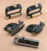 Angle guide jigs and woodworking tool accessories on a wooden workbench for precise cutting