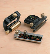 Woodworking sharpening jig set with brass and metal components on a light wood surface