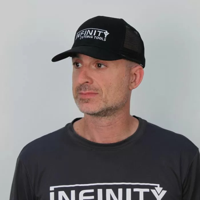 Man wearing black Infinity Cutting Tools mesh trucker hat and matching logo t-shirt