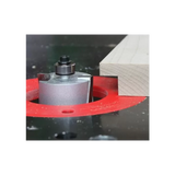 Router bit cutting a rabbet joint in wood on a router table